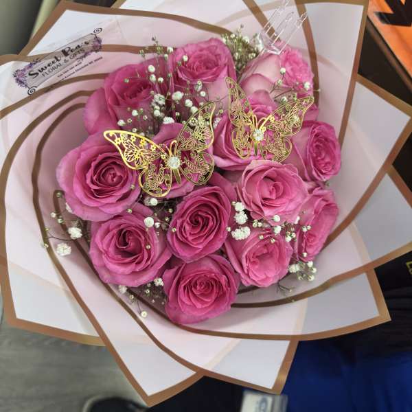 Pink rose bouquet with baby’s breath and butterfly picks