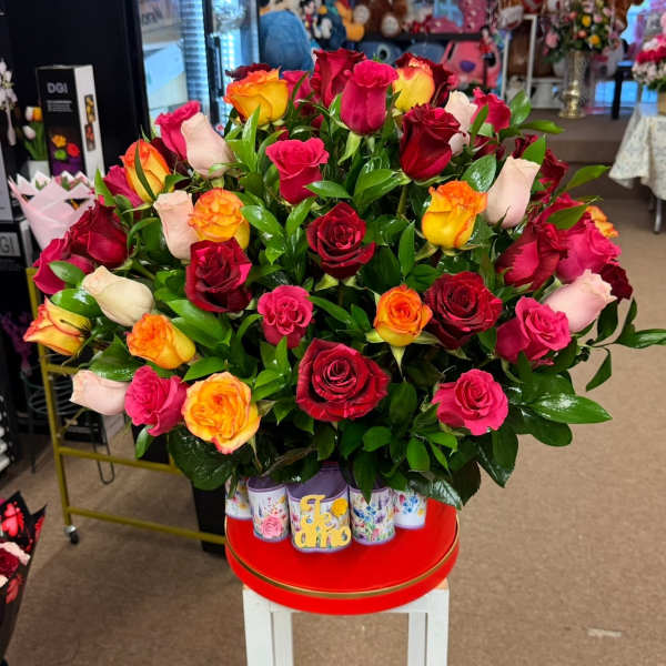 Large bouquet of multicolored roses in a decorative container