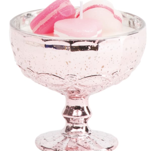 Pink glass pedestal bowl holding pastel macarons