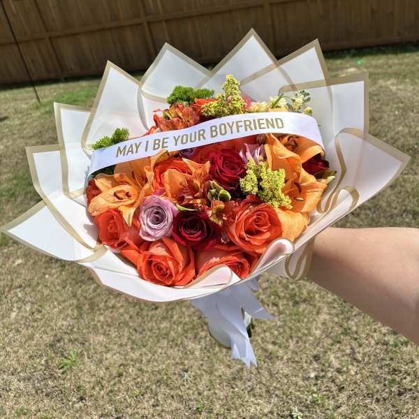 Bouquet of orange and red roses with a "MAY I BE YOUR BOYFRIEND" sash