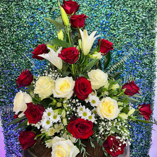 Tall bouquet of red and white roses with lilies and daisies