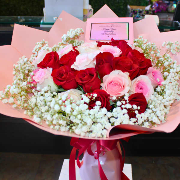 Bouquet of red and pink roses wrapped in pink paper
