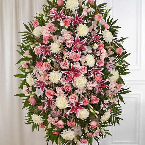 Large standing spray of pink and white flowers with lilies and roses