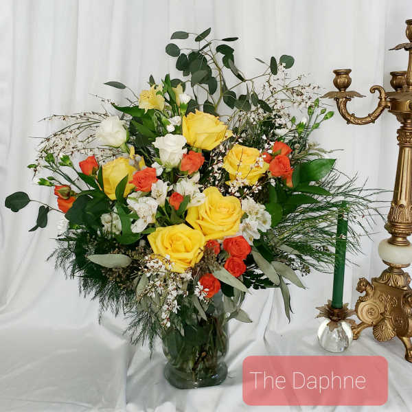Yellow and orange rose arrangement in a glass vase