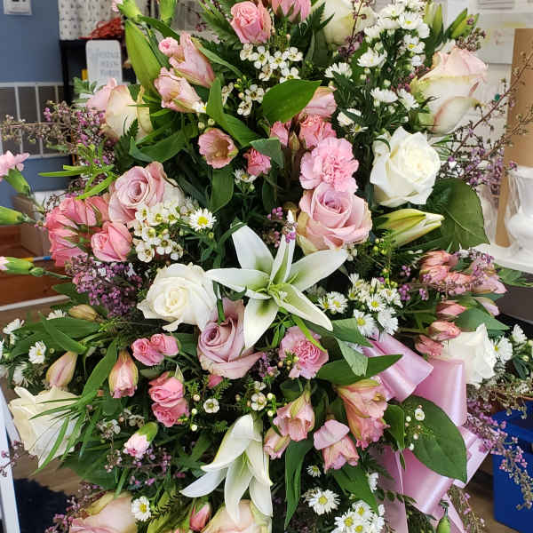 Large pink and white floral standing spray with ribbon