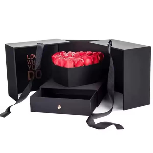 Red roses in a black gift box with ribbon handles