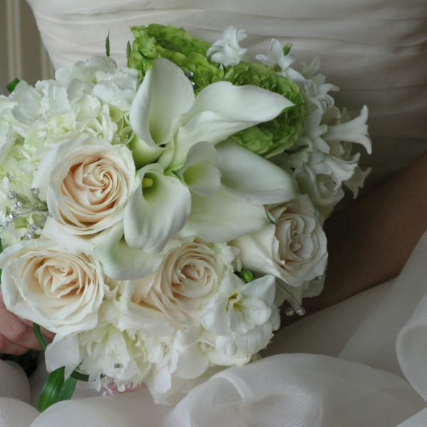 White bridal bouquet with roses, calla lilies, and hydrangea