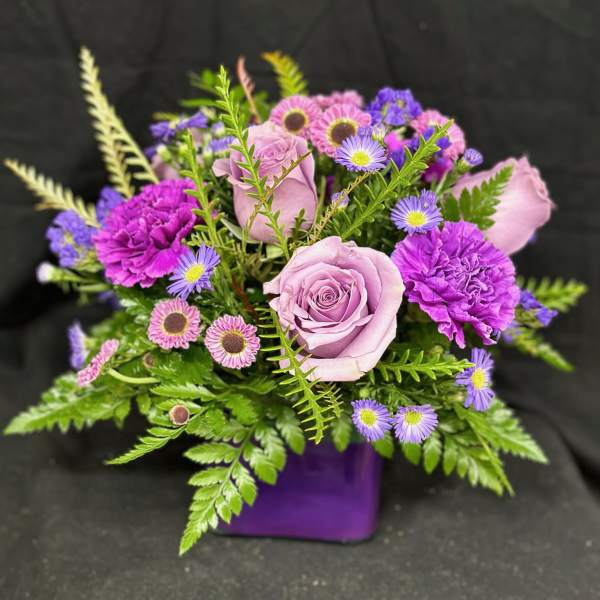 Purple and pink bouquet in a purple vase
