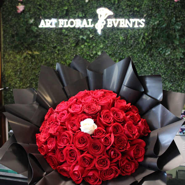 Large bouquet of red roses wrapped in black paper