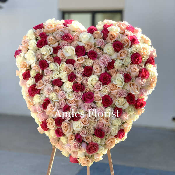 Heart-shaped rose arrangement on a stand