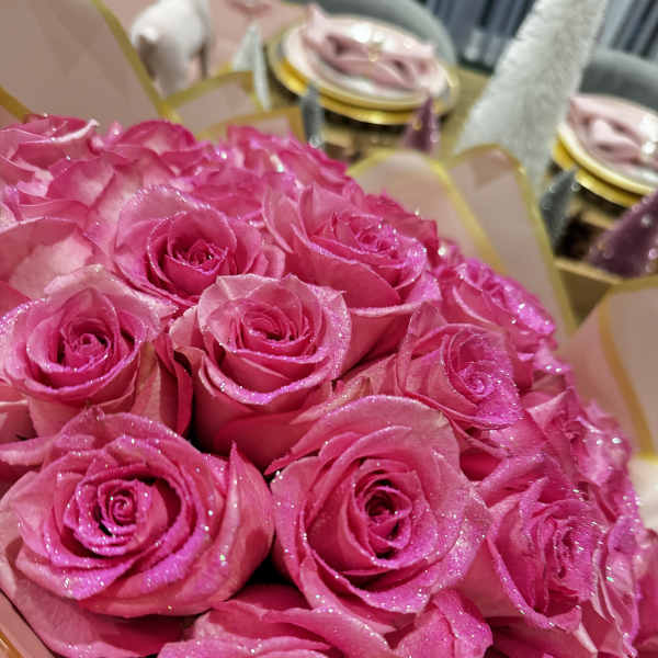 Bouquet of bright pink roses with glittery petals