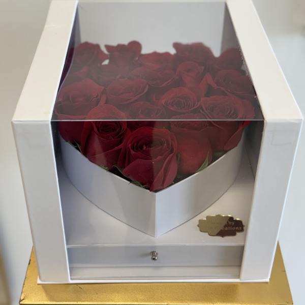 Boxed arrangement of red roses in a white gift box