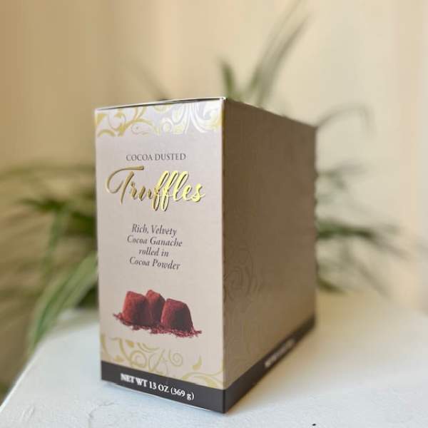 Box of cocoa-dusted truffles on a table