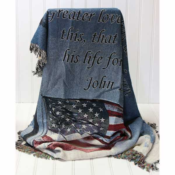 Folded patriotic throw blanket with text and an American flag design