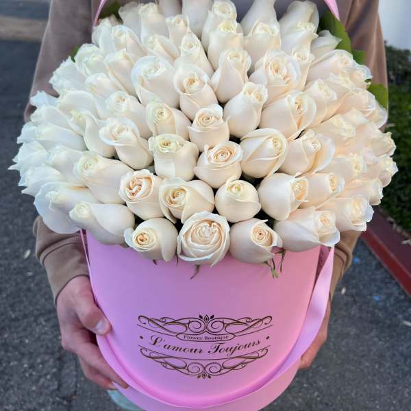 Large bouquet of white roses in a pink hatbox