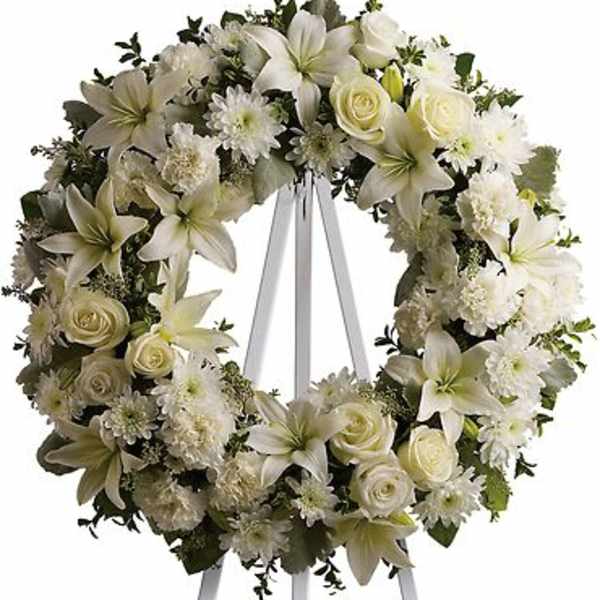 White floral wreath on a standing easel