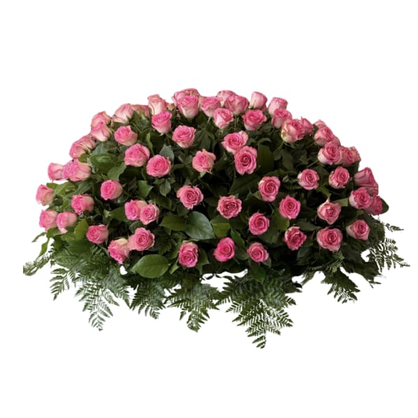 Large dome-shaped spray of pink roses with a border of ferns