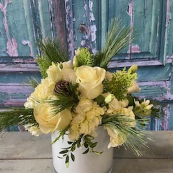 Cream-colored floral arrangement in a white vase