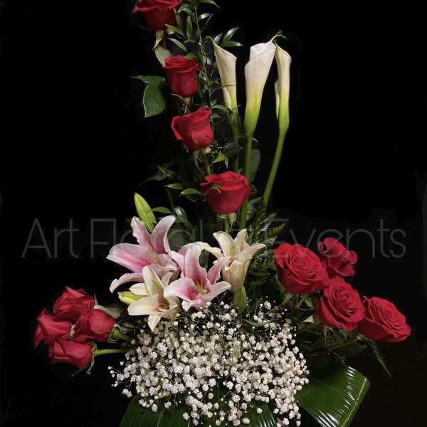 Tall arrangement of red roses, pink lilies, and white calla lilies