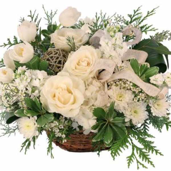 White roses and small white flowers in a wicker basket