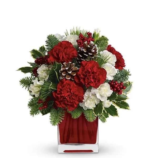 Red and white floral arrangement in a clear square vase