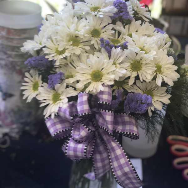 White daisy bouquet with purple accents and a plaid ribbon