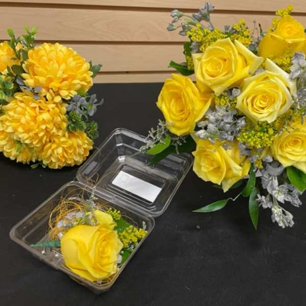 Yellow rose arrangements with yellow chrysanthemums and a clear plastic box
