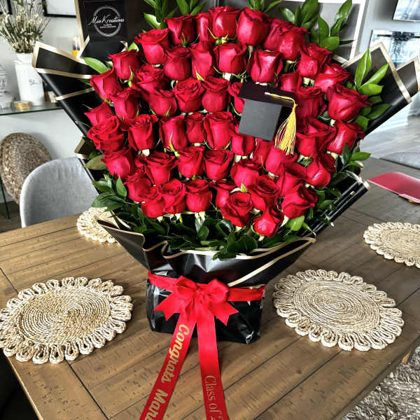 Large bouquet of red roses wrapped in black paper with a red ribbon