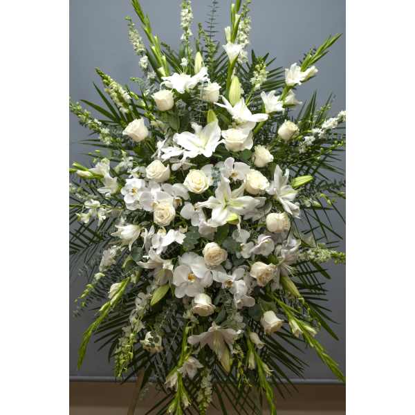 Tall white floral standing spray with roses, orchids, and lilies