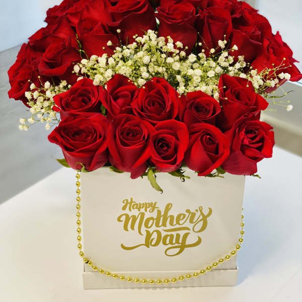 Red roses arranged in a white box with a gold Happy Mother's Day message