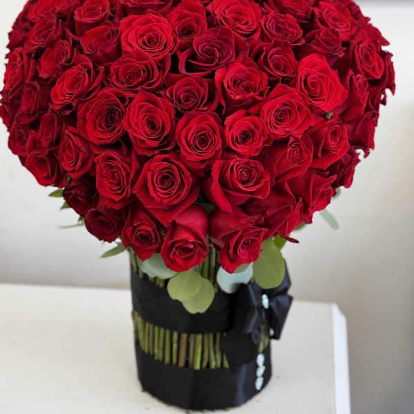 Large bouquet of red roses in a black wrap