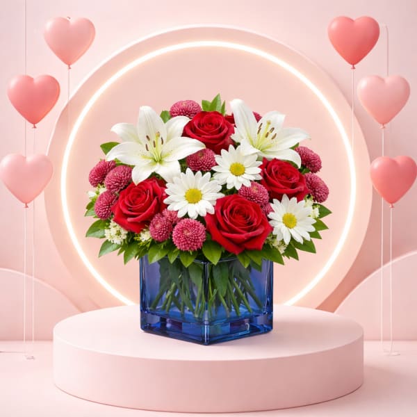 Bouquet of red roses, white lilies, and daisies in a blue vase with heart balloons