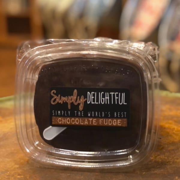 Chocolate fudge in a clear plastic container with a label