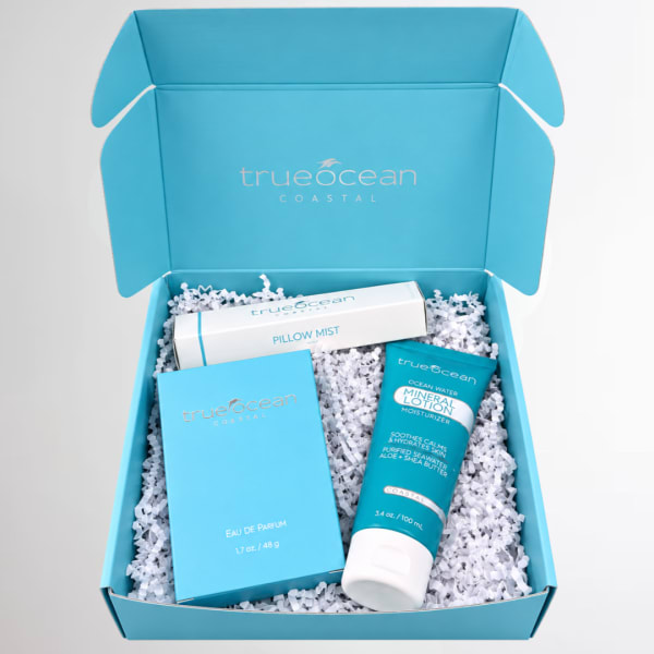 Blue gift box with perfume, pillow mist, and lotion