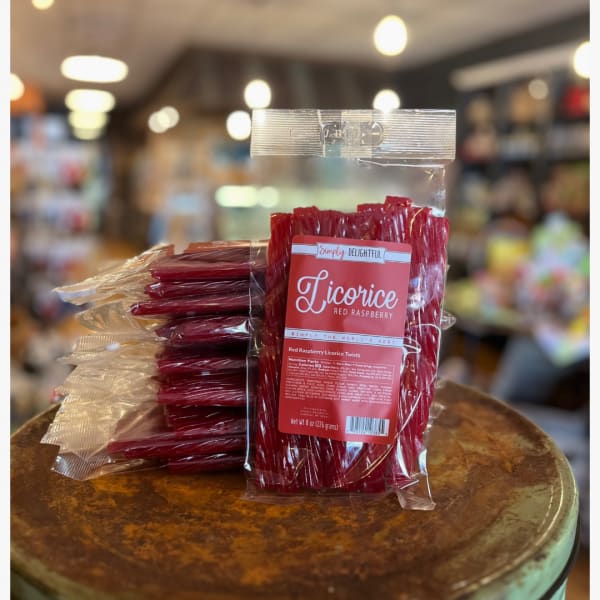 Bagged red raspberry licorice twists on a round display table