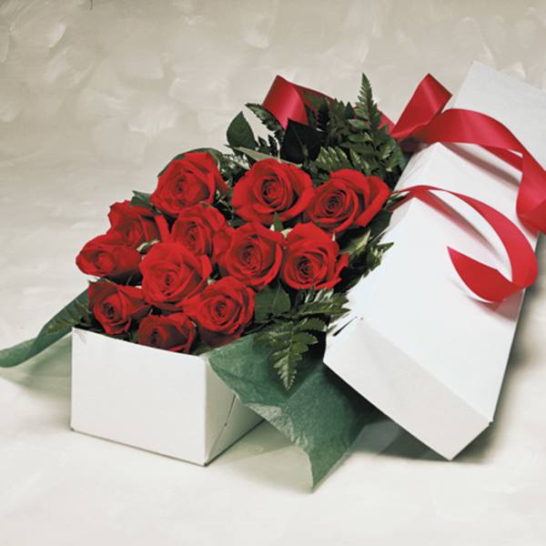 Box of red roses with a red ribbon
