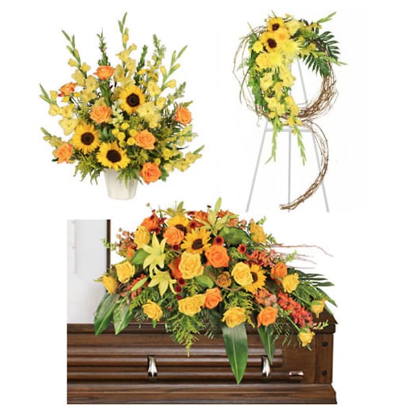 Yellow and orange floral funeral pieces arranged around a casket