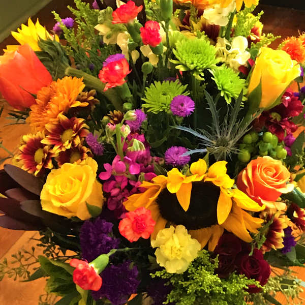 Mixed bouquet of bright flowers in a glass vase
