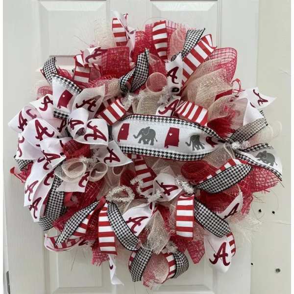 Red, white, and black Alabama-themed ribbon wreath on a door