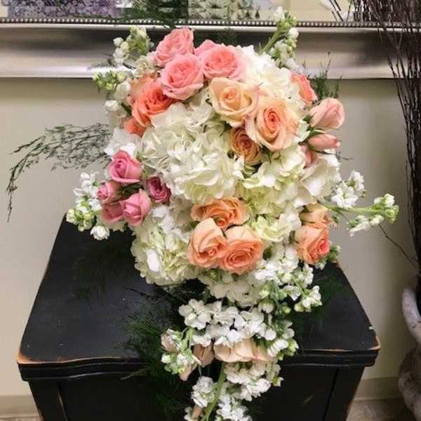 Cascade bouquet of pink and peach roses with white hydrangeas