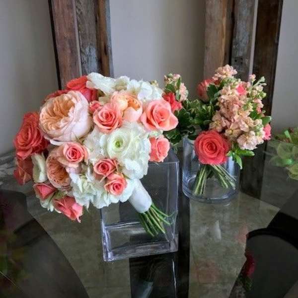 Bouquets of pink and white roses in clear glass vases