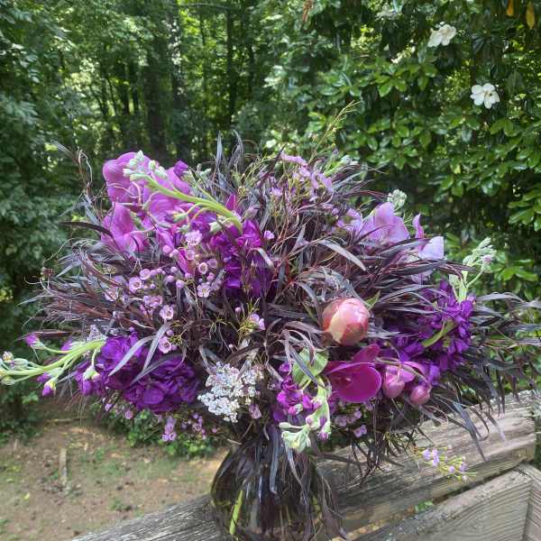 Purple floral bouquet in a glass vase
