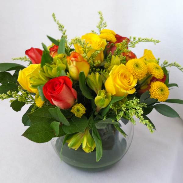 Bouquet of red and yellow roses in a glass vase