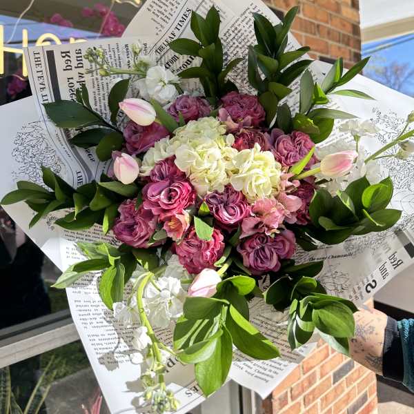 Pink and white bouquet with roses, hydrangea, and tulips in paper wrap
