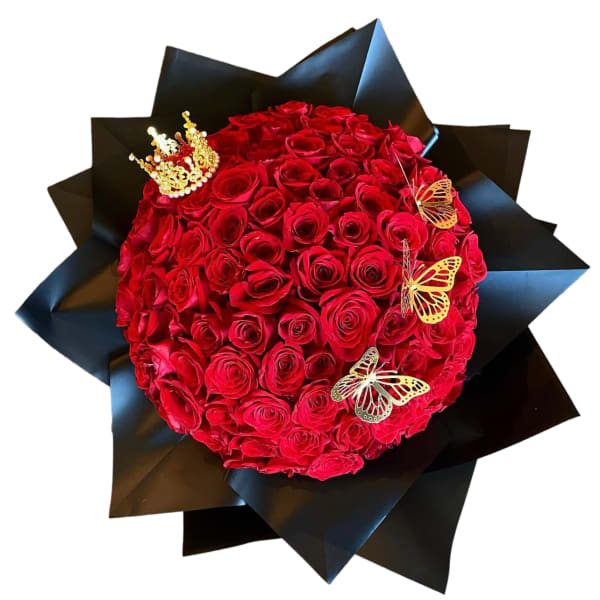 Round bouquet of red roses wrapped in black paper with butterfly accents