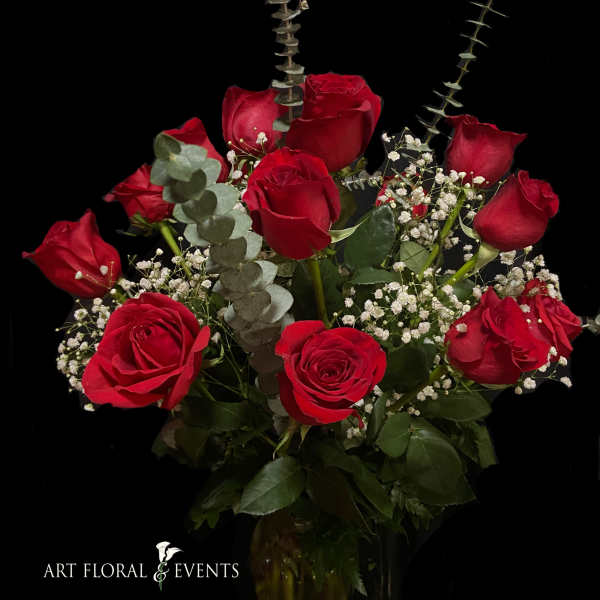 Bouquet of red roses with baby's breath and eucalyptus in a vase