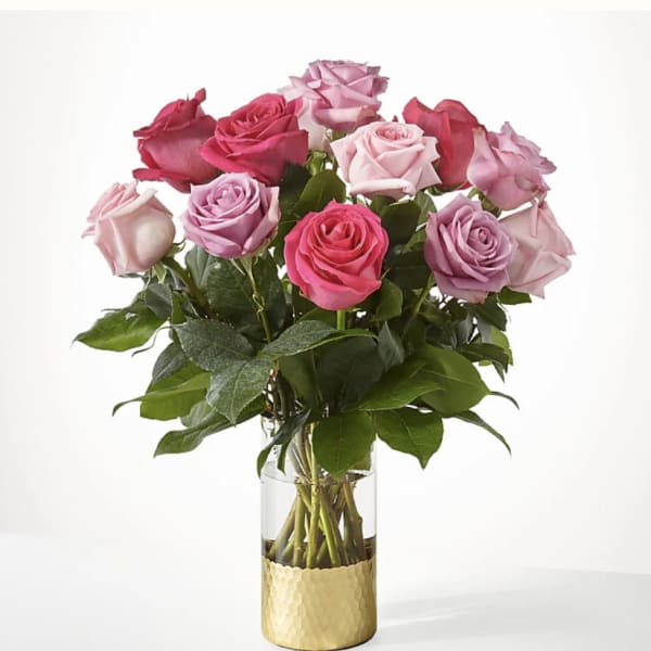Bouquet of pink and lavender roses in a glass vase