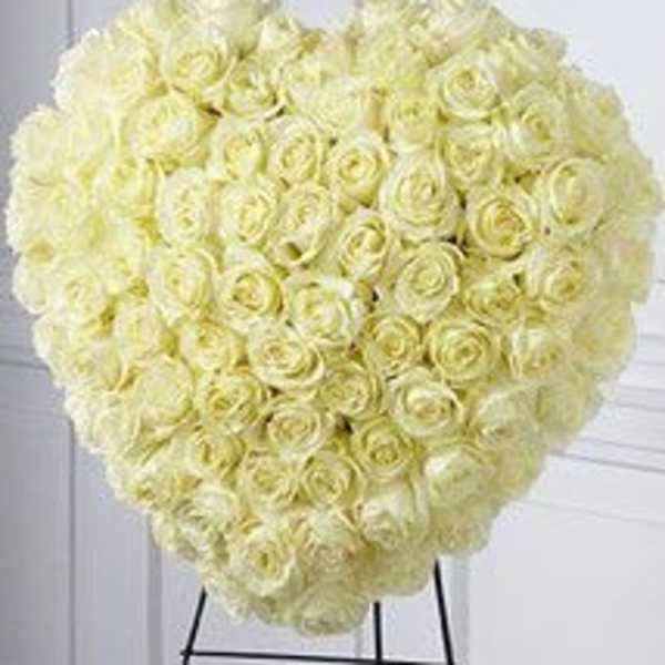 Heart-shaped bouquet of pale yellow roses on a stand