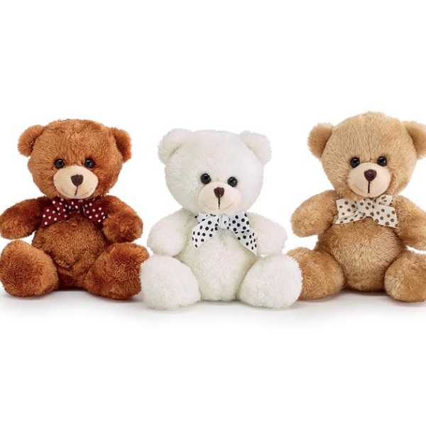 Three plush teddy bears with polka-dot bows on a white background
