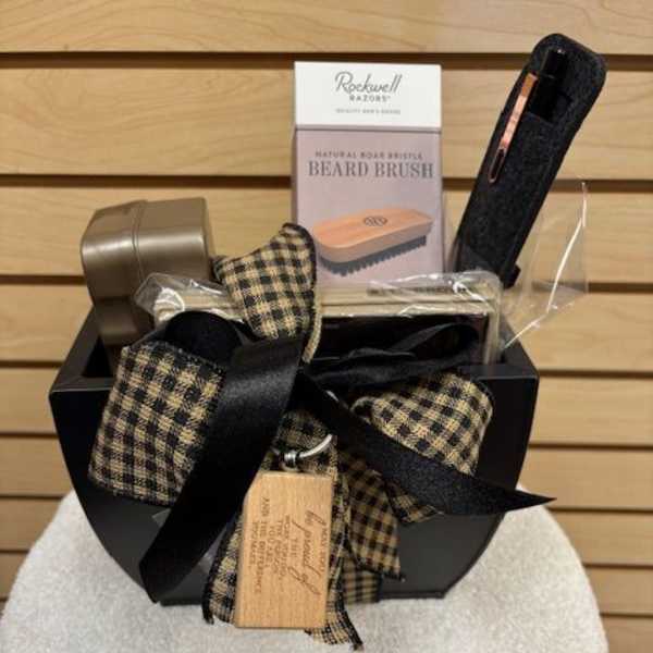 Gift basket with beard brush and grooming items tied with plaid ribbon